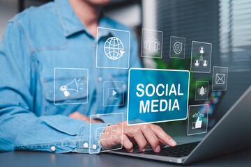 Wall Mural - social media marketing and digital engagement concept. a person using laptop with virtual icons and 