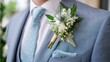 © fotofabrika - Elegant groom's attire featuring a blue suit and fresh floral boutonniere for a wedding celebration in spring