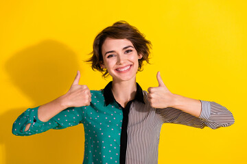 Poster - Photo of cheerful glad lovely girl wear stylish striped clothes thumb up sign isolated on yellow color background