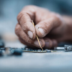 Poster - Closeup of a skilled hand meticulously repairing intricate electronics. Represents precision, craftsmanship, technology, and the dedication to problemsolving.