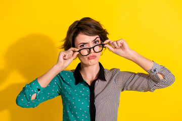 Poster - Photo of minded clever woman wear stylish clothes touch glasses hmm isolated on yellow color background