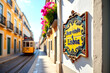 © PrismaVibe Studio  - Decorative ceramic tile sign reading 'Bem Vindo a Lisboa' placed in front of a scenic view with traditional Lisbon houses and a classic yellow tram