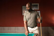 © ADDICTIVE STOCK - Man playing pool in a coworking space