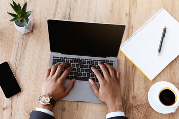Aufkleber - Top view of black businessman typing on modern laptop with empty screen, african american manager working online in his office, having online conference or video call with business partners, mockup