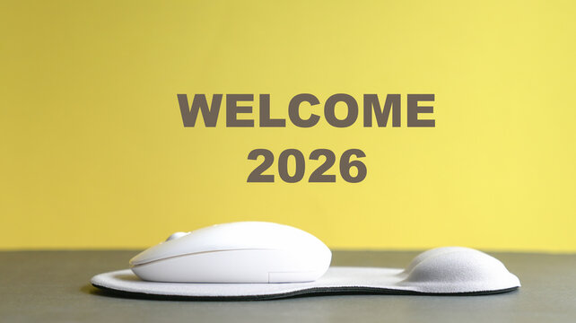 Welcome new year 2026, text on top of computer mouse and mousepad.