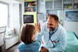 © Davor - Happy pediatrician giving high five to child patient during doctor visit in medical clinic
