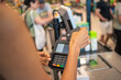 © tessy morelli/Stocksy - Anonymous hand paying with credit card at supermarket