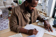 © Jovo Jovanovic/Stocksy - Business owner working on taxes