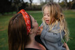 © Rob and Julia Campbell/Stocksy - Mother and Child Enjoying a Happy Moment Outdoors Together
