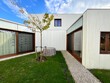 © Melissa Milis Photography/Stocksy - modern architectural design with outdoor space and tree