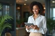 © Vadym - Happy latin business woman uses tablet device. Smiling mature female executive working at office, using fintech tab application. Person in formal wear looks at screen. Happy, satisfied.