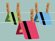 © Xènia Besora Sala/Stocksy - Colorful bank cards clipped with pins on string