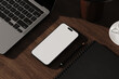 © Oleksandr Shcherban/Stocksy - Smartphone with blank screen on wooden desk in modern workspace