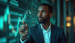 © Vadym - Black man in suit analyzes stock market charts. Financial analyst trading, monitoring business graphs on digital display. African american trader at work. Successful entrepreneur, broker, investor,