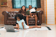 © chokniti - Heartwarming family moment as an African American father and daughter share playful time together on the couch, surrounded by love, laughter, and the warmth of home, while mom gently looks on with joy