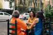 © Daniel Zapata/Stocksy - Three women sit on the terrace of an outdoor café.