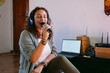 © Ezequiel Giménez/Stocksy - Singer practicing vocal exercises with microphone