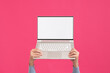 © Sibila and Pavel/Stocksy - Person holding modern laptop with blank screen. Mock-up.