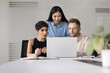 © fizkes - Three teammates using laptop engaged in teamwork in modern office, busy in project progress review, analyzing next steps, make financial data analysis, consider charts, collaborating on presentation