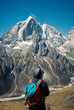 © Ayuna Production/Stocksy - Hiker overlooking towering snowy peaks in the Himalayas