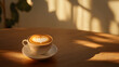 © Jorda - Cup of coffee with heart-shaped latte art on a wooden table bathed in sunlight