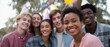 © Mind - Group of friends wearing party hats smiles at birthday celebration