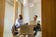 © BONNINSTUDIO/Stocksy - Two businessmen discussing strategy in modern office meeting room