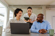 © BONNINSTUDIO/Stocksy - Business team collaborating on laptop in modern office