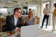 © BONNINSTUDIO/Stocksy - Formal business people working on laptop in modern office restaurant