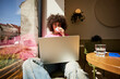 © Ivan Jovanovic/Stocksy - Woman uses a laptop in a cafe