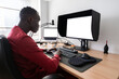 © Alvaro Lavin/Stocksy - Video editor working from home using professional monitor