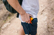 © Mami Kumagai/Stocksy - Man pulls out his disposable camera in his pocket during a hike