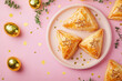 © xadartstudio - Festive pastries golden eggs and confetti on pink background