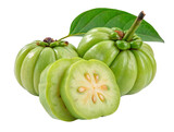 A close up of three garcinia cambogia fruits, one sliced, with a leaf, on a white background space