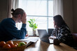 © Johnér - Stressed mature couple sitting at table in home