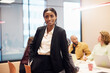 © Johnér - Portrait of confident female entrepreneur standing with hand in pocket at office
