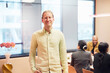 © Johnér - Portrait of smiling male entrepreneur standing in office board room