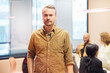 © Johnér - Portrait of confident businessman standing in office meeting room