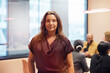 © Johnér - Portrait of confident mature female business professional standing in office board room