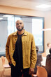 © Johnér - Portrait of confident bald businessman standing with hand in pocket at office board room