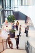 © Johnér - High angle view of male and female business professionals talking with each other at networking event