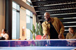 © Johnér - Happy male entrepreneur playing table tennis in office