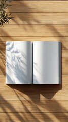 Poster - Open Blank Book on Wooden Table With Leaf Shadow, Representing Creativity and Content Marketing, Ready for Your Message or Design : Generative AI
