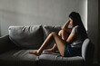 © pitipat - Silhouette photo of young Asian woman feeling upset, sad, unhappy or disappoint crying lonely in her room. Young people mental health care problem lifestyle concept.