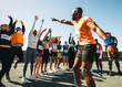 © Jacob Lund - Dynamic running club with coach energizing the group