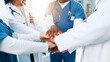 © peopleimages.com - Healthcare, nurses and doctors with hands for huddle, teamwork and motivation in hospital for work. People, employees or medical diversity with stack to celebrate, solidarity or collaboration support