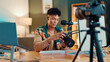 © peopleimages.com - Influencer, camera and man with mic for review, podcast or social media promotion. Filming, product or content creator show tech for photography, ratings or picture quality for live streaming at home