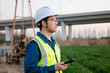 © zhu difeng - asian male engineer using smart phone in construction site