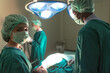 © Jack Tamrong - Male and female surgeon team working with serious operation in operating room