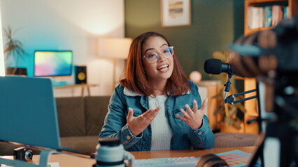 Poster - Influencer, talking and woman live streaming in home for broadcast, entertainment and internet vlog. Content creator, social media and person recording video, podcast and gaming review to audience